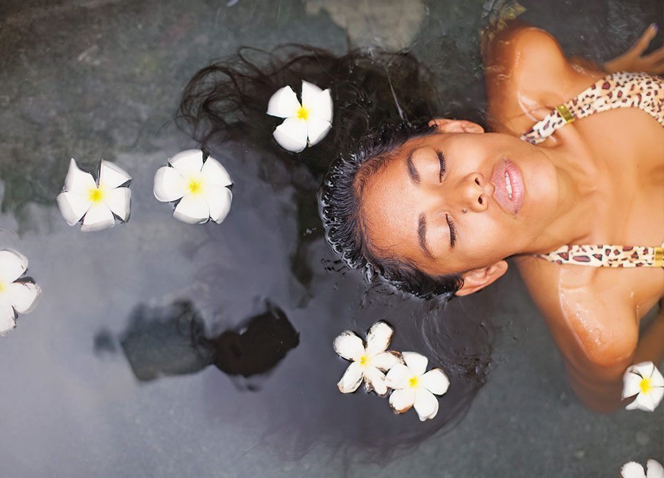 Beautiful exotic woman having bath in a luxury spa salon
