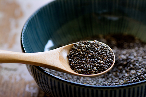 Brown wooden spoonful of chia seeds