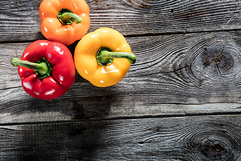 colorful bell peppers on authentic old wood copy space