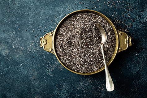 Chia seeds on dark baclground directly above copy space