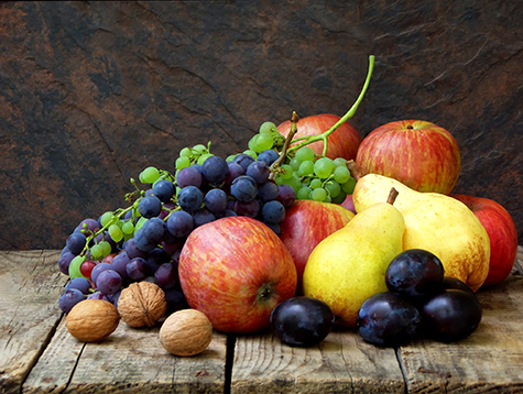still life of autumn fruits: grapes, apples, pears, plums, nuts