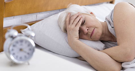 SEnior woman suffering from insomnia in bed