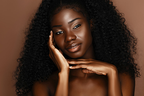 African  skincare models with perfect dark skin and curly hair. Beauty spa treatment concept.