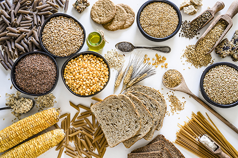 Dietary fiber: large group of wholegrain food shot from above on white background