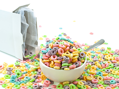 Cereal loops mess in bowl isolated on white