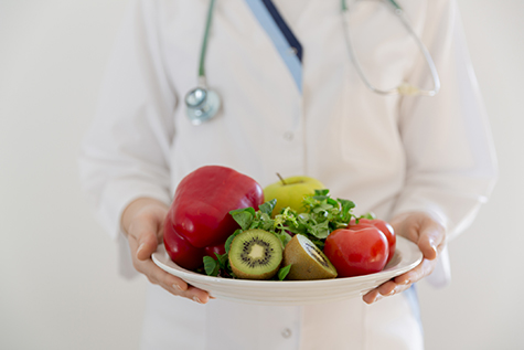 Nutritionist, doctor holding fresh fruit and vegetable, Healthy diet, Nutrition food as a prescription for good health.Weight loss and right nutrition concept