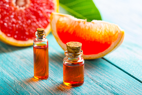 citrus oil cosmetic grapefruit medicine health nature glass vial wooden background