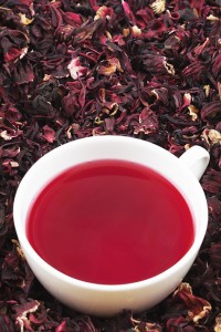 Cup of hibiscus tea on the leaves.