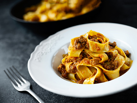 rustic italian pappardelle bolognese pasta in meat sauce