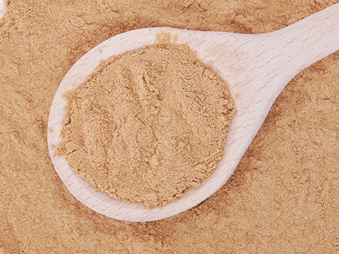 Mesquite powder in wooden spoon