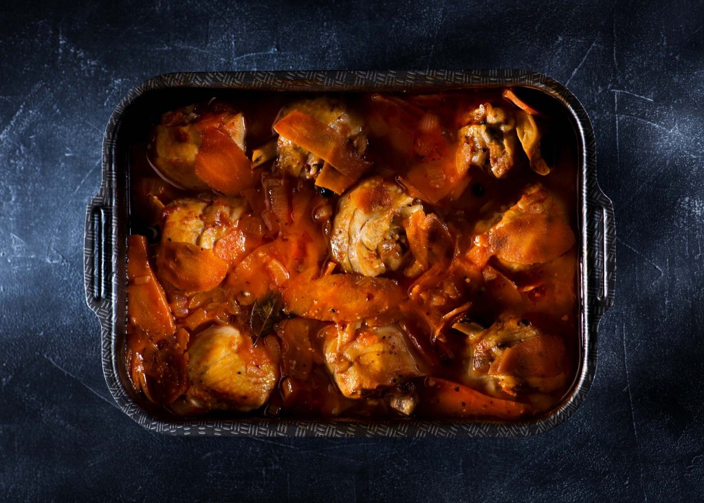 Stewed chicken legs with vegetables in spicy tomato sauce