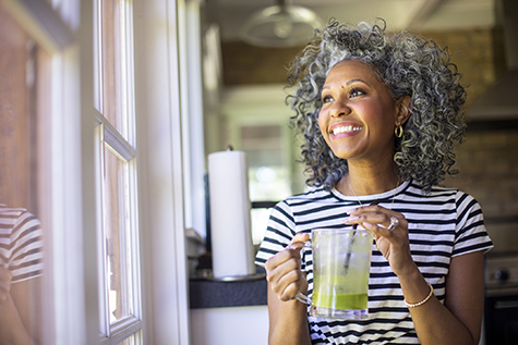 Mature Black Woman Drinking a Green Smoothie