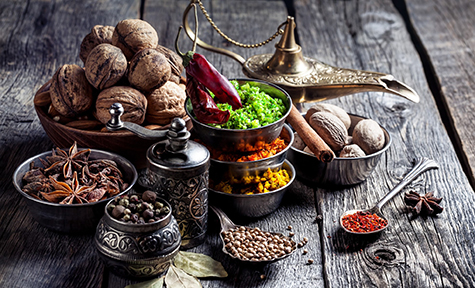 Spices and nuts at wooden table