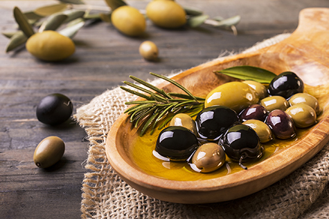 mixed olives with rosemary in the foreground