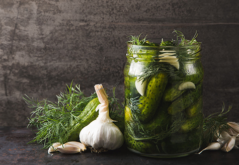 Glass jar of pickles with dill and garlic