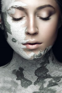 Beautiful woman with silver cosmetic mask covering her face