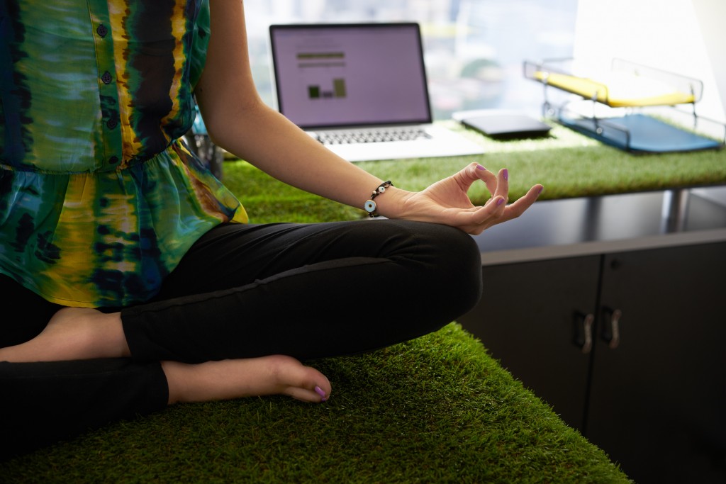 Business Woman Doing Yoga Meditation On Office Desk