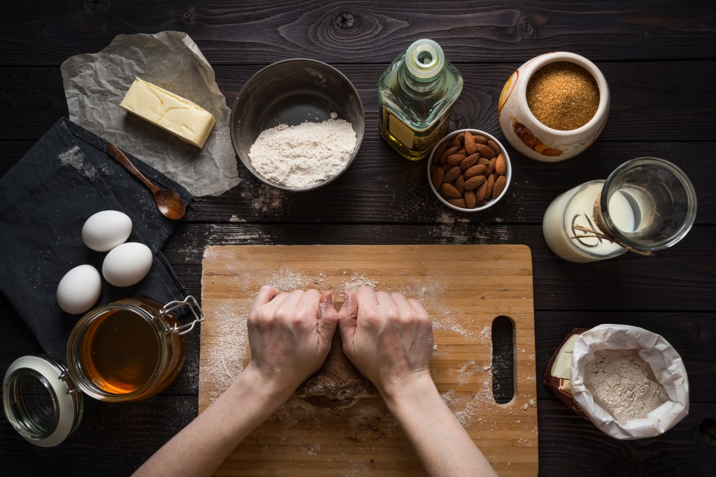 Kneading dough for baking among the ingredients, view from above