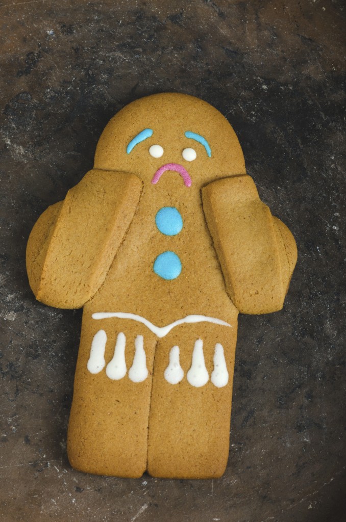 Sad gingerbread man on a ceramic plate