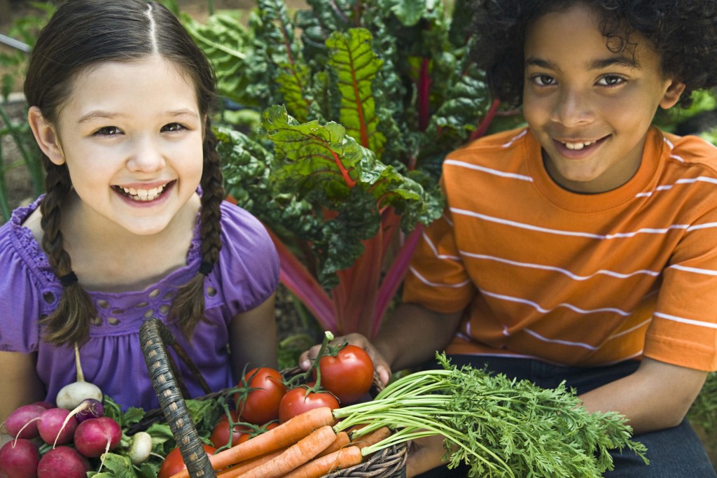 Children with fresh produce in basket