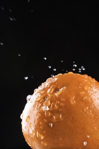 Orange with water droplets splashing