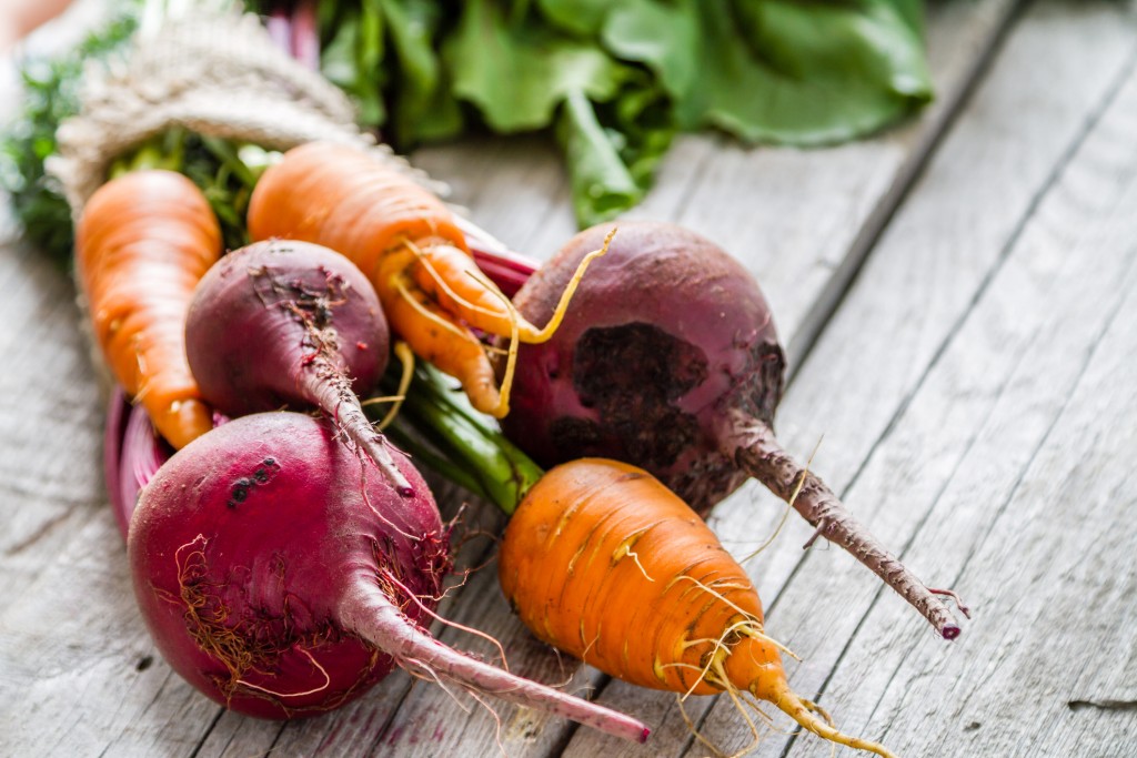 Carrot and beet on rustic background