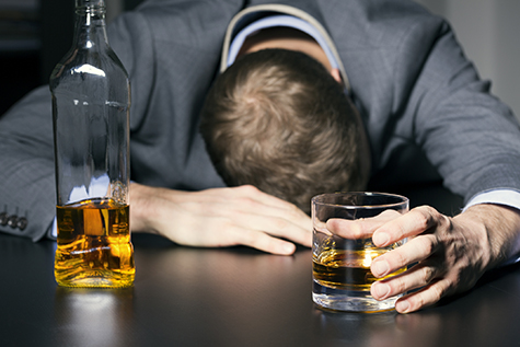 alcohol addiction - drunk businessman holding a glass of whiskey