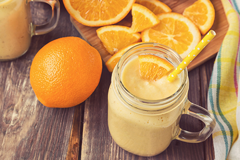Orange fruit smoothie in the glass jar