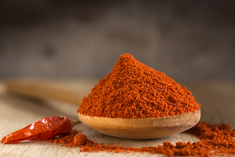 Spoon filled with red hot paprika powder