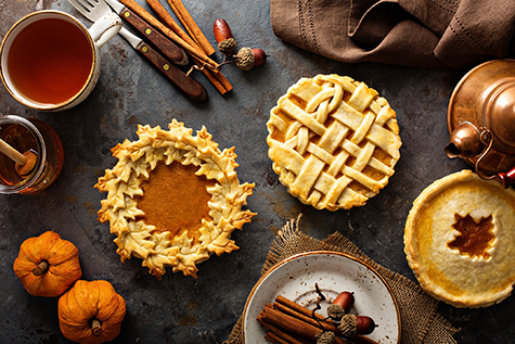 Homemade pumpkin pies decorated with fall leaves