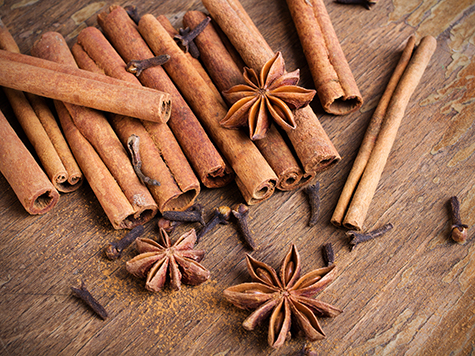 cinnamon sticks, star anise and cloves on wooden background