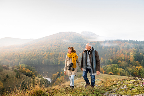 Senior couple on a walk in an autumn nature.