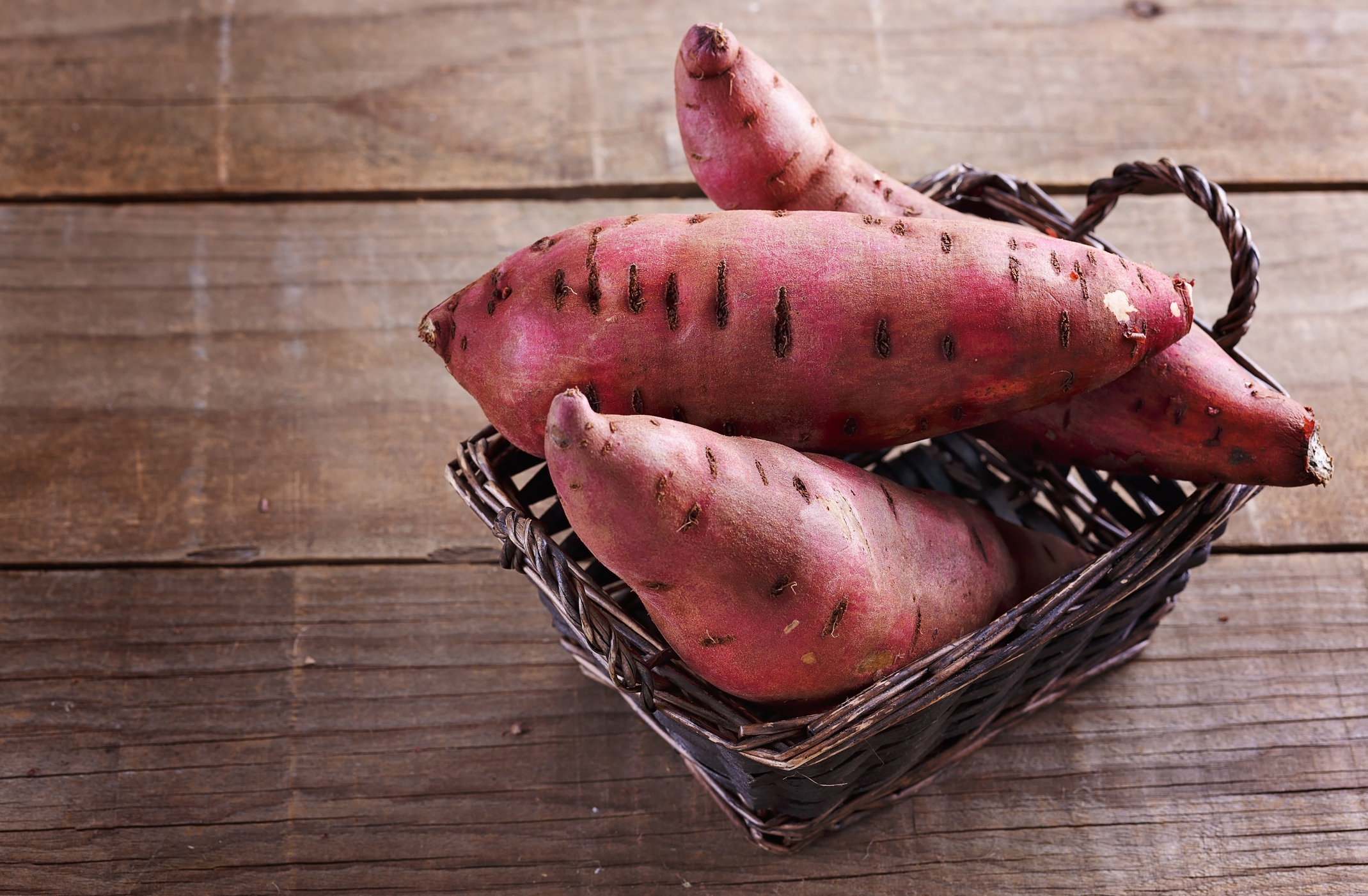 Sweet potato over rustic wooden background